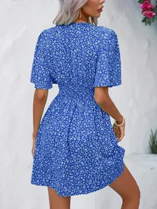 Back view of a bohemian blue ditsy floral print dress with smocked high waist and a-line skirt