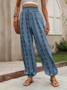 Bohemian blue high-waist lantern pants with ethnic geometric patterns on a model