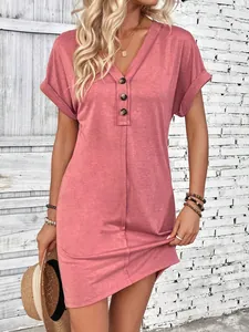 Detailed view of women's summer V-neck dress featuring button accents and rolled sleeves