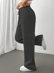 Side view detail of dark grey wide-leg cargo sweatpants featuring a drawstring waist.