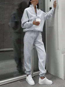 Detail view of grey two-piece casual tracksuit with half-zip sweatshirt and joggers