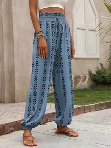 Detailed view of light blue ethnic print lantern pants featuring elastic waist and drawstring