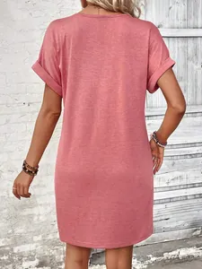 Back view detail of a casual coral pink solid color t-shirt dress with rolled sleeves