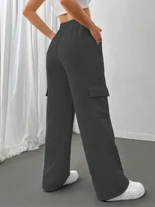 Back view of women's dark grey cargo sweatpants with side pockets and wide leg fit