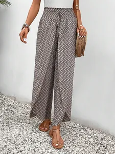 Detail view of high-waist wide-leg pants featuring a side slit and geometric print