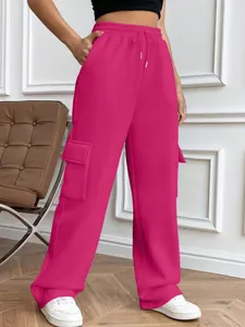 Close-up detail view of women's hot pink high-waisted cargo sweatpants with side pockets