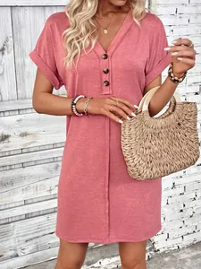Close-up detail of a dusty rose V-neck summer dress featuring decorative buttons
