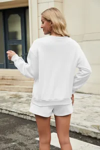 Back view of a white two-piece sweatshirt and shorts set for women on a blonde model