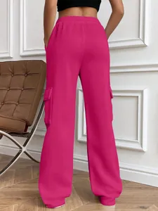Detailed back view of women's hot pink wide-leg cargo sweatpants featuring side pockets