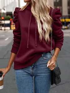 Close-up of burgundy long-sleeved hooded sweatshirt featuring stylish puffed shoulders