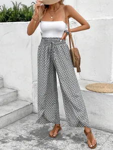 Detail of floral wide-leg palazzo pants with stylish side slits for summer wear.