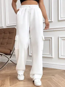 Close-up detail of stylish white cargo wide-leg sweatpants featuring side flap pockets