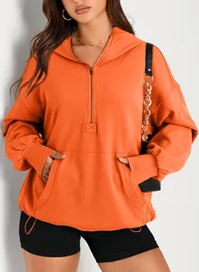 Macro view of women's vibrant orange half-zip hooded sweatshirt featuring a kangaroo pocket