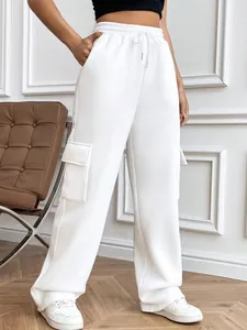 Detail of white wide-leg cargo sweatpants with drawstring waist and side flap pockets.