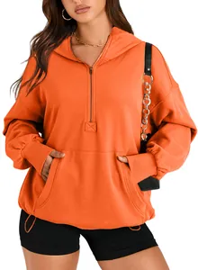 Close-up detail of a bright orange women's hooded sweatshirt featuring a quarter-zip.
