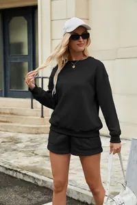 Fashionable two-piece set featuring a black sweatshirt and matching shorts on a model.