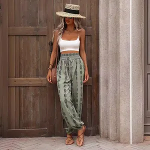 Boho print sage green wide-leg lantern pants for summer casual wear outdoors.