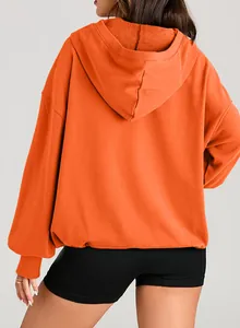 Back view of a vibrant orange oversized hoodie showing hood texture and relaxed fit