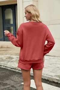 Back view of a women's solid red sweatshirt and shorts two-piece loungewear set