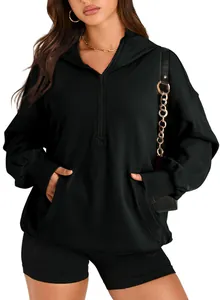 Detailed view of women's black half-zip hoodie with a kangaroo pocket and hood