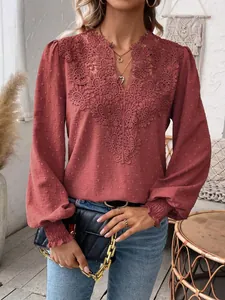 Detailed view of elegant V-neck lace embroidery on long sleeve terracotta blouse