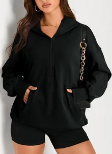 Close-up detail of a black oversized quarter-zip hooded sweatshirt with front pocket