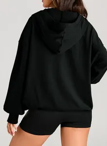 Back view of a premium black oversized hooded sweatshirt for women in a studio setting