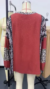 Detail view of a women's color-block sweatshirt with leopard print sleeves and ribbed texture.