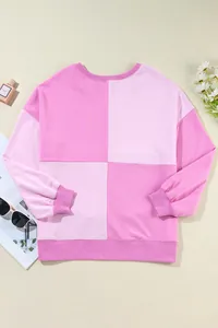Detailed flat lay view of a casual pink colorblock long-sleeved sweatshirt with ribbing.