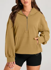 Close-up of a women's khaki half-zip hooded sweatshirt featuring a front pocket