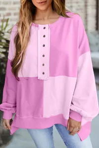 Detailed view of women's color-block patchwork sweatshirt with button placket