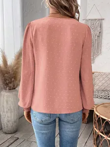 Back view of pink Swiss dot long sleeve blouse paired with stylish casual denim jeans