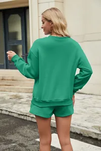 Rear view of a green two-piece sweatshirt and shorts set for women in a street setting