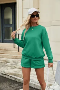 Women's bright green two-piece sweatshirt and shorts set worn in outdoor street style