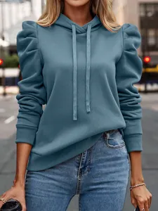 Detail view of stylish blue long sleeve hooded sweatshirt with unique puff sleeves