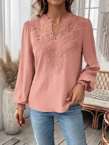 Detailed view of pink V-neck blouse with intricate lace trim and swiss dot texture