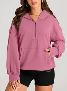 Detail view of pink women's half-zip hoodie with kangaroo pocket and hooded design