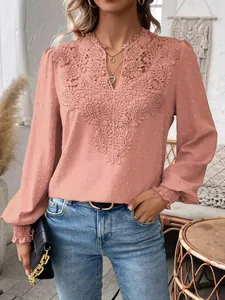 Close-up detail view of pink V-neck lace blouse with Swiss dot pattern and sleeves