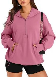 Detail shot of a pink half-zip women's hoodie with a functional front pocket.