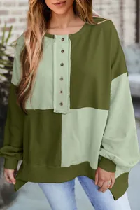 Close-up of olive green color-block Henley sweatshirt with buttoned placket details