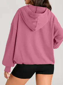 Detailed back view of a women's oversized solid dusty pink long sleeve hooded sweatshirt