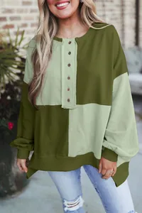 Detail of women's oversized color-block buttoned sweatshirt in olive and sage green
