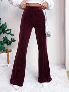 Close-up of burgundy high-waisted corduroy flared pants with ribbed texture.