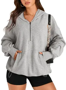 Detail view of a women's grey long-sleeved hoodie with quarter zip and front pockets.