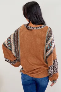 Back view of women's casual mixed pattern pullover with leopard and tribal prints.