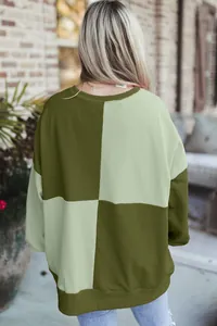 Back view of an oversized green color-block sweatshirt with a soft ribbed hem and neckline.