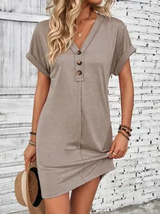 Fashionable taupe V-neck mini dress featuring button details and rolled sleeves