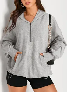 Detail view of women's gray half-zip oversized hooded sweatshirt with front pocket