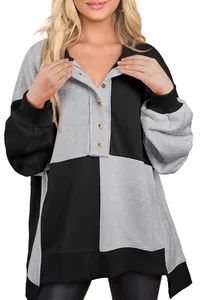 Long-sleeve grey and black color-block sweatshirt with button-down collar detail.