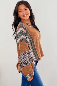 Detail of women's boho patchwork sweatshirt with leopard print and ethnic patterns.